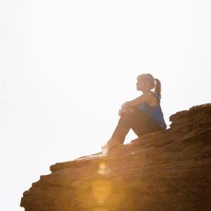 teenager sitting on rock